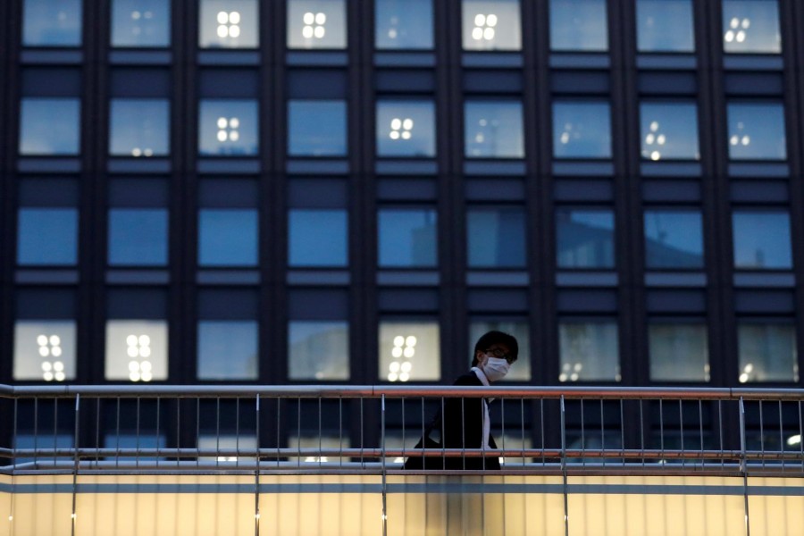 A man wearing a protective mask walks at a business district amid the coronavirus disease (COVID-19) outbreak in Tokyo, Japan, May 12, 2020. REUTERS/Kim Kyung-Hoon/File Photo