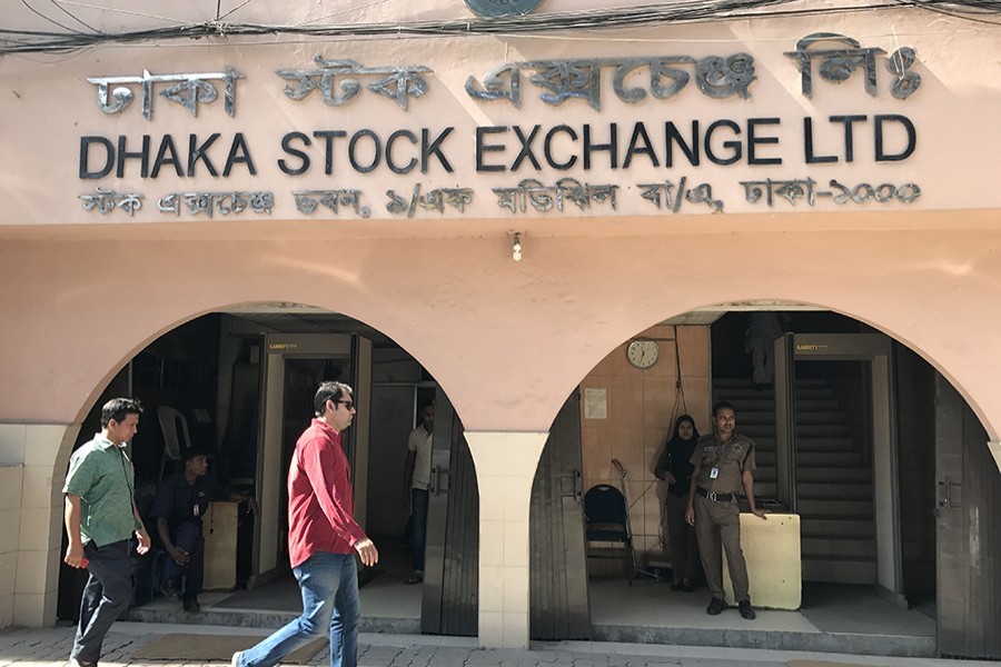 Pedestrians walk past the Dhaka Stock Exchange office building at Motijheel in Dhaka — FE/Files