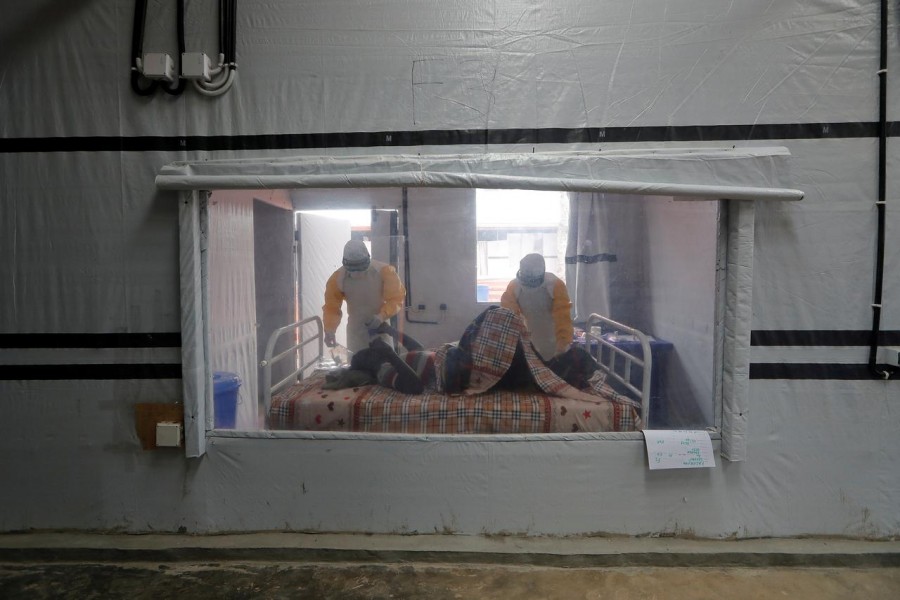 Moise Vaghemi, 33, (L) an Ebola survivor who works as a nurse cares for a patient who is suspected to be suffering from Ebola, inside the Biosecure Emergency Care Unit (CUBE) at the Ebola treatment centre in Katwa, near Butembo, in the Democratic Republic of Congo on October 3, 2019 — Reuters/Files