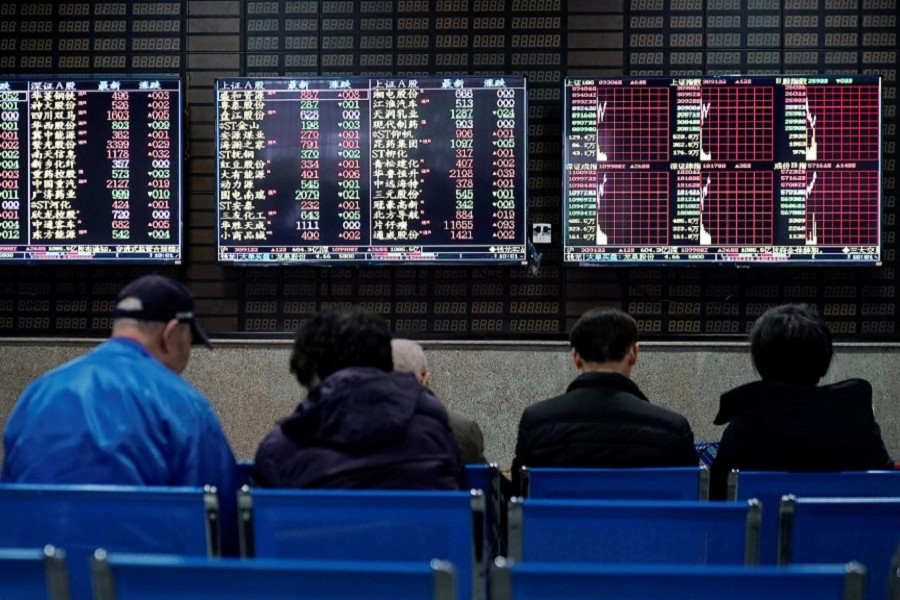 Investors look at screens showing stock information at a brokerage house in Shanghai, China, January 16, 2020. — Reuters/Files