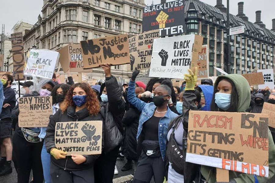 Demonstrators holding signs during a Black Lives Matter protest in Parliament Square, following the death of George Floyd who died in police custody in Minneapolis, in London, Britain on Saturday. –Reuters Photo