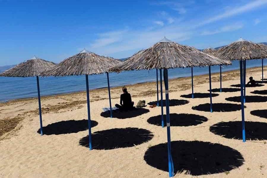 A woman sits at Peraia beach as Greece begins a gradual easing of the nationwide lockdown due to the spread of the coronavirus disease (Covid-19), in Thessaloniki, Greece, May 05, 2020 — Reuters/Files