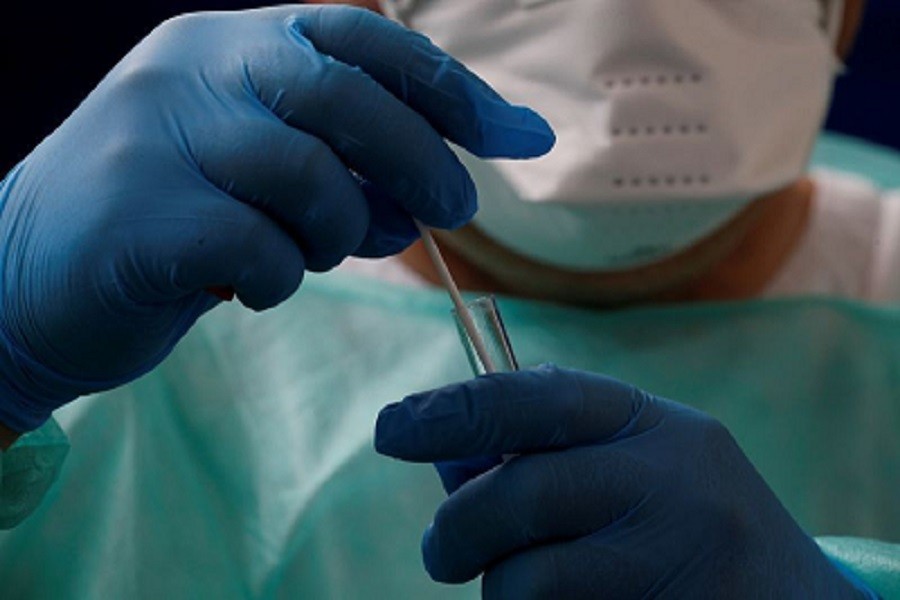 A French doctor, wearing a protective suit and a face mask, holds a test tube after administering a nasal swab to a patient at a testing site for coronavirus disease (Covid-19) in Cambrai, following the outbreak of the coronavirus disease (Covid-19) in France, July 09, 2020 — Reuters/Files