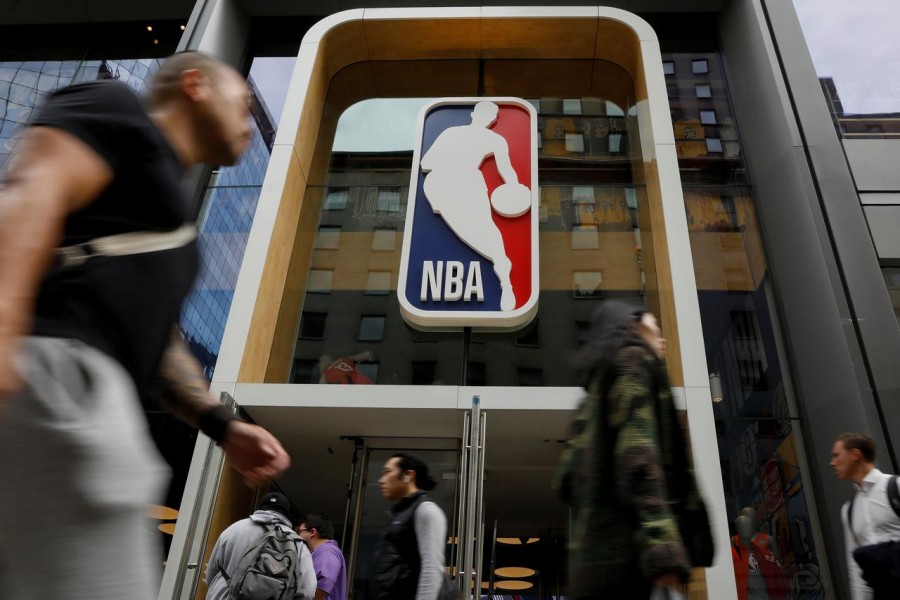 The NBA logo is displayed as people pass by the NBA Store in New York City, US on October 7, 2019 — Reuters/Files