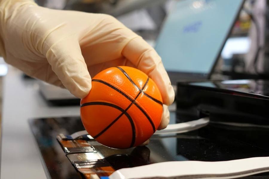 Dr. Benjamin Tee, Assistant Professor of Materials Science and Engineering at the National University of Singapore (NUS), demonstrating how his device can detect the texture of a soft stress ball at a lab in NUS, Singapore last week –Reuters Photo