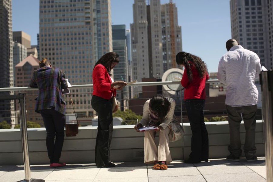 FILE PHOTO: Job seekers apply for the 300 available positions at a new Target retail store in San Francisco, California August 09, 2012. REUTERS/Robert Galbraith/File Photo/File Photo