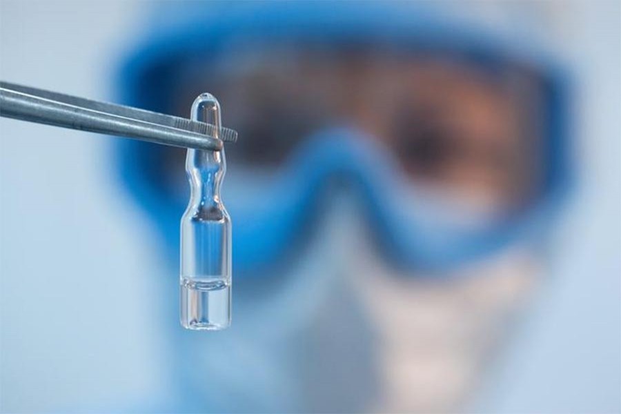 FILE PHOTO: A handout photo shows an employee demonstrating a vial with "Gam-COVID-Vac" vaccine against the coronavirus disease (COVID-19), developed by the Gamaleya National Research Institute of Epidemiology and Microbiology and the Russian Direct Investment Fund (RDIF), during its production at Binnopharm pharmaceutical company in Zelenograd near Moscow, Russia August 7, 2020. The Russian Direct Investment Fund (RDIF)/Andrey Rudakov/Handout via REUTERS