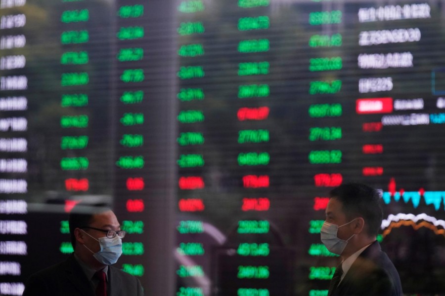 Men wearing face masks are seen inside the Shanghai Stock Exchange building, as the country is hit by a novel coronavirus outbreak, at the Pudong financial district in Shanghai, China, February 28, 2020 — Reuters