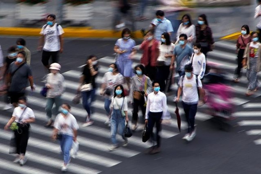 People wearing face masks walk on a street in Shanghai, following the coronavirus disease (Covid-19) outbreak, China, July 16, 2020 — Reuters/Files