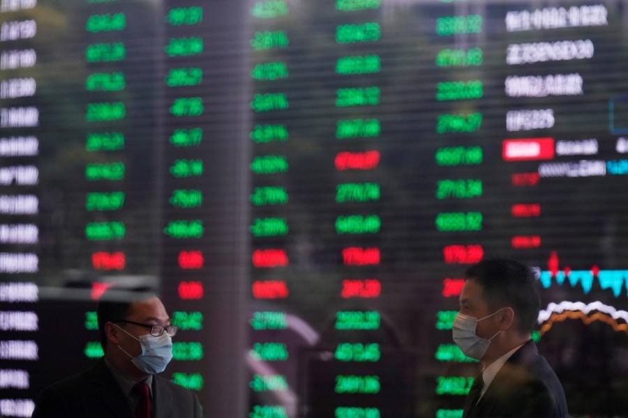 Men wearing face masks are seen inside the Shanghai Stock Exchange building, as the country is hit by a novel coronavirus outbreak, at the Pudong financial district in Shanghai, China, February 28, 2020 — Reuters/Files