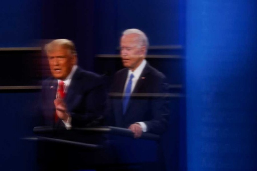 US President Donald Trump and Democratic presidential nominee Joe Biden are reflected in the plexiglass protecting a tv camera operator from Covid as they participate in their second 2020 presidential campaign debate at Belmont University in Nashville, Tennessee, US, October 22, 2020 — Reuters