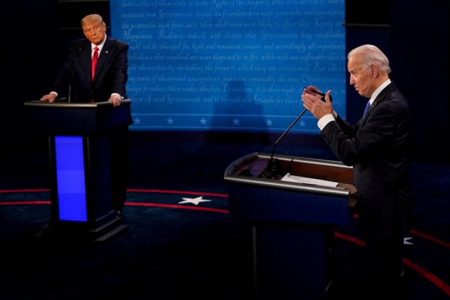 Democratic presidential candidate former Vice President Joe Biden answers a question as President Donald Trump listens during the second and final presidential debate at the Curb Event Center at Belmont University in Nashville, Tennessee, US, October 22, 2020 —Reuters