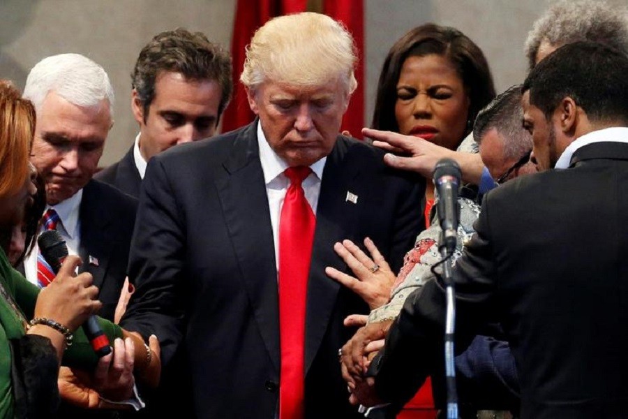 Members of the clergy lay hands and pray over Donald Trump at the New Spirit Revival Center in Cleveland Heights, Ohio — Reuters/Files