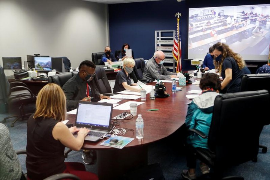 Members of the Pinellas County canvassing board count ballots on Election Day in Largo, Florida, US, November 3, 2020 — Reuters