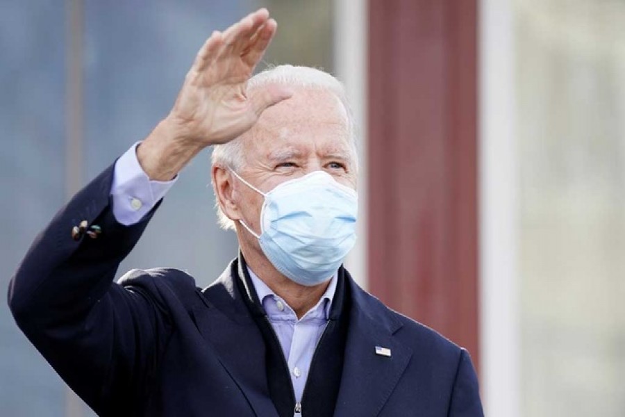 US Democratic presidential nominee Joe Biden waves to his supporters outside of a restaurant, on Election Day in Philadelphia, Pennsylvania, US, Nov 3, 2020. REUTERS