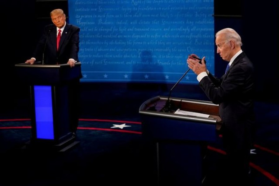 Democratic presidential candidate former Vice President Joe Biden answers a question as President Donald Trump listens during the second and final presidential debate at the Curb Event Center at Belmont University in Nashville, Tennessee, US, October 22, 2020. Morry Gash/Pool via REUTERS/File Photo