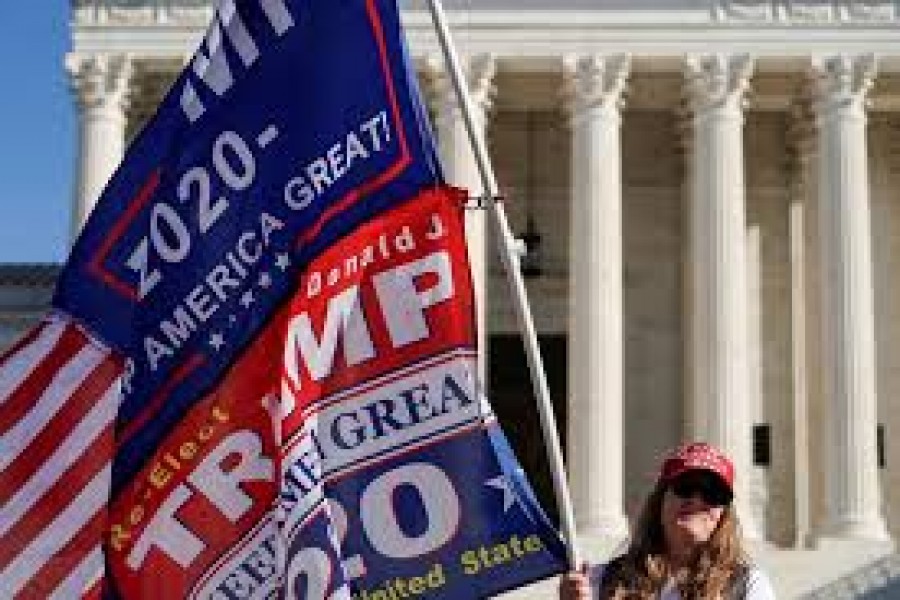 Kathleen Kratt, of Orlando, Florida, and a supporter of US President Donald Trump holds a flag in front of the Supreme Court as the court reviews a lawsuit filed by Texas seeking to undo President-elect Joe Biden's election victory in Washington, US, December 11, 2020 — Reuters