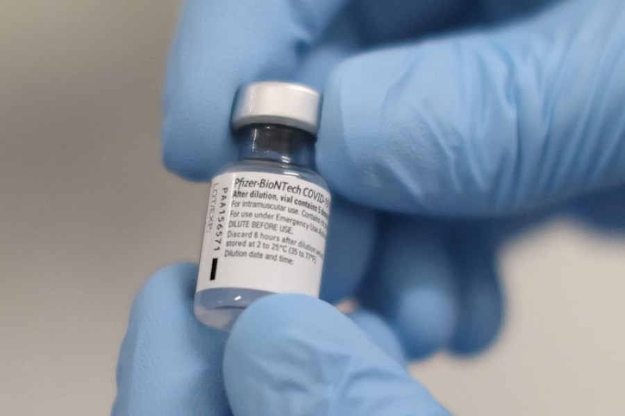 A vial of the Pfizer/BioNTech COVID-19 vaccine is seen ahead of being administered at the Royal Victoria Hospital, on the first day of the largest immunisation programme in the British history, in Belfast, Northern Ireland December 8, 2020. Liam McBurney/Pool via REUTERS/File Photo