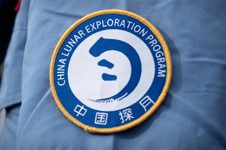 A patch for the China Lunar Exploration Program is displayed on the uniform of a worker at the Wenchang Space Launch Site in southern China's Hainan province [File: Mark Schiefelbein/AP Photo]