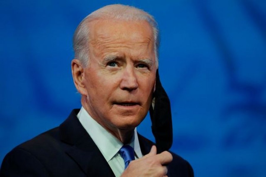 US President-elect Joe Biden takes off his protective face mask to deliver a televised address to the nation, after the US Electoral College formally confirmed his victory over President Donald Trump in the 2020 US presidential election, from Biden's transition headquarters in Wilmington, Delaware, US, December 14, 2020 — Reuters