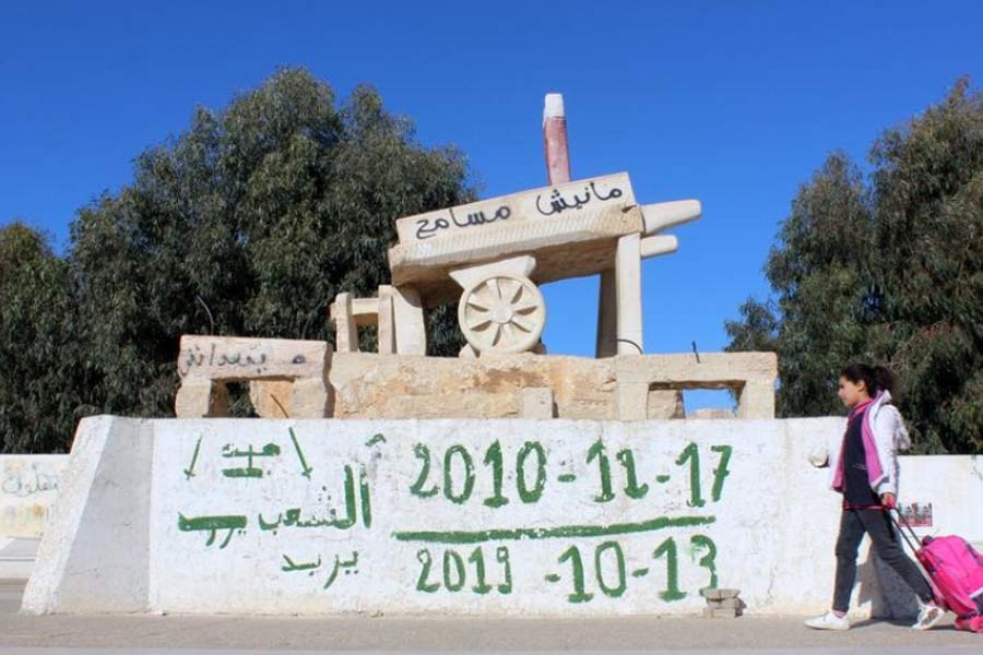 A girl walking past a memorial for Mohamed Bouazizi, a street vendor who set himself alight 10 years ago on December 17, 2010, in Sidi Bouzid, Tunisia on December 8 this year –Reuters photo