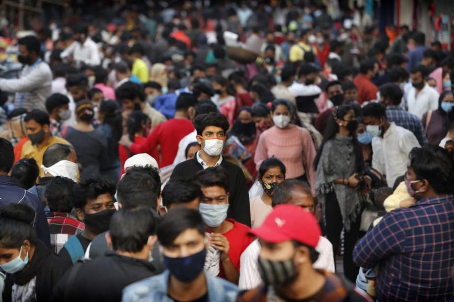 Indians wearing face masks as a precaution against the coronavirus shop at a market in New Delhi, India recently –AP file photo