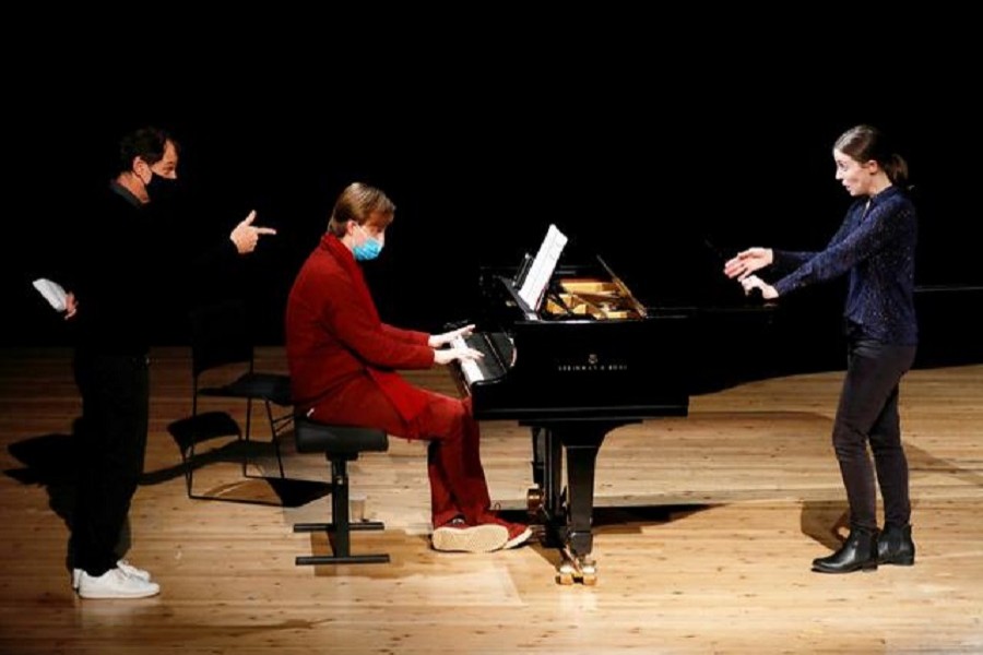 Director Simon Valastro, pianist Christiphe Vazan and singer Pauline Texier, members of the Opera de Paris Academy, rehearse at the Bastille Opera in Paris as French theatres, cinemas and museums which have been on the second-wave Covid-19 lockdown will not reopen this year in France, December 11, 2020 — Reuters