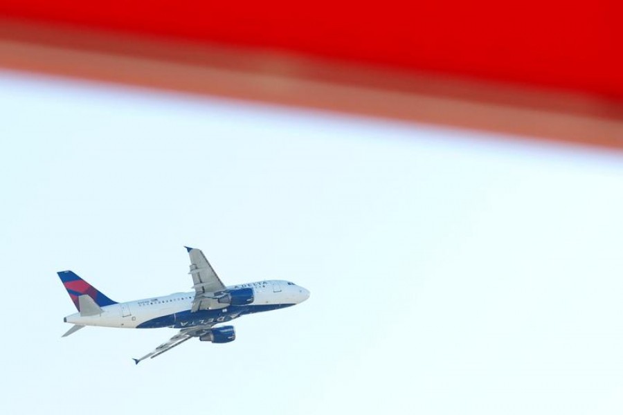 An airplane flies over Hartsfield–Jackson Atlanta International Airport in Atlanta, Georgia, US, November 23, 2020. REUTERS/Chris Aluka Berry