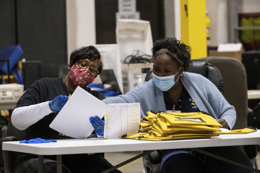 Elections workers at the Fulton County Georgia elections warehouse check in voting machine memory cards that store ballots following the Senate runoff election in Atlanta on Tuesday, Jan. 5, 2021 - AP Photo/Ben Gray