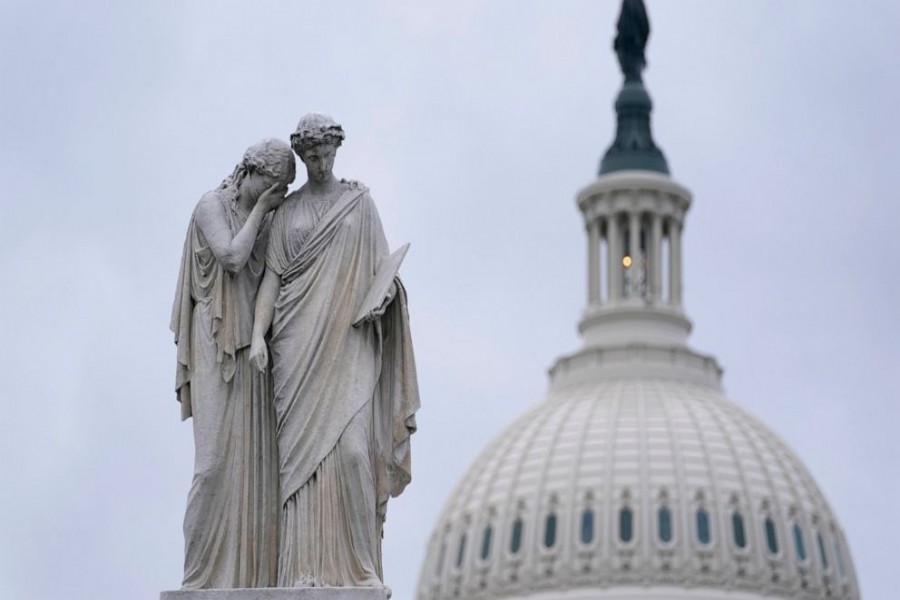 The Peace Monument, also known as the Naval Monument or Civil War Sailors Monument, is framed by the Capitol dome on Capitol Hill in Washington, Monday, Jan 4, 2021. (AP Photo/Susan Walsh)