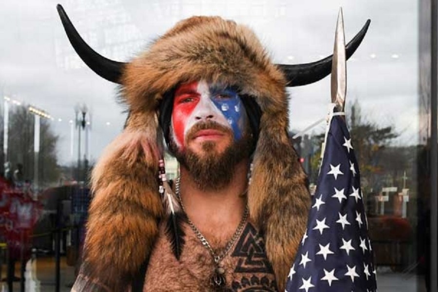 A man with his face painted in the colours of the U.S. flag poses for a picture as supporters of U.S. President Donald Trump gather (not pictured) in Washington, Jan 6, 2021. REUTERS