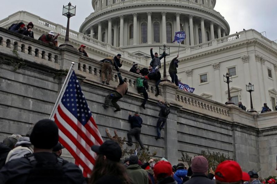 Supporters of US President Donald Trump climb a wall during a protest against the certification of the 2020 presidential election results by the Congress, at the Capitol in Washington, US on January 6, 2021 — Reuters/Files