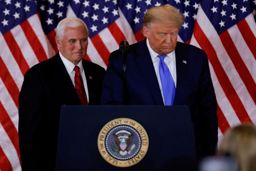 US President Donald Trump and Vice President Mike Pence stand while making remarks about early results from the 2020 US presidential election in the East Room of the White House in Washington, US, November 4, 2020. REUTERS/Carlos Barria/File Photo