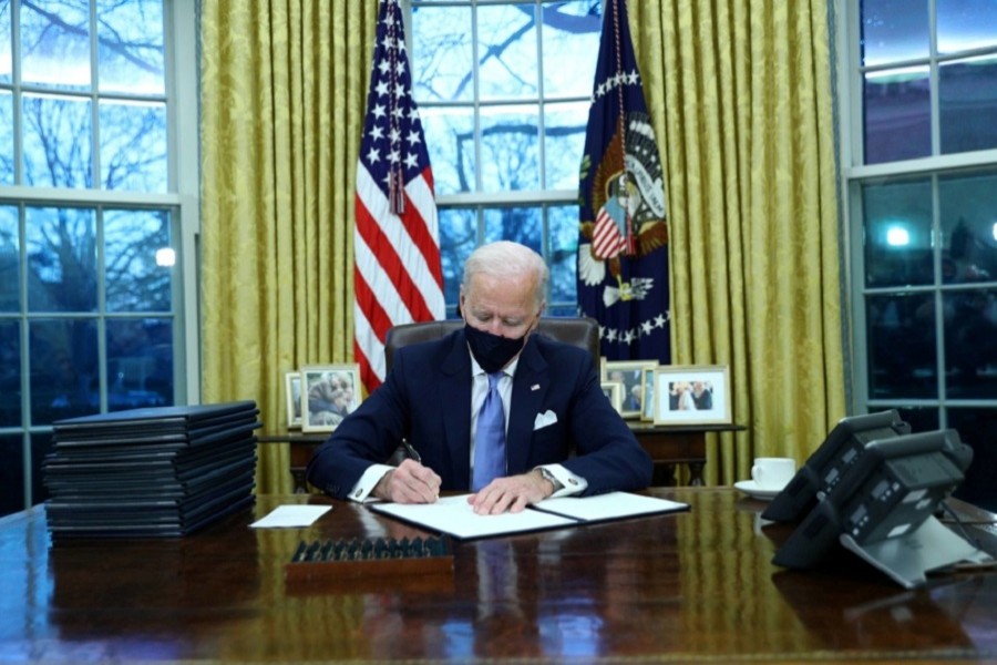 US President Joe Biden signs executive orders in the Oval Office of the White House in Washington, after his inauguration as the 46th President of the United States, US, January 20, 2021 — Reuters