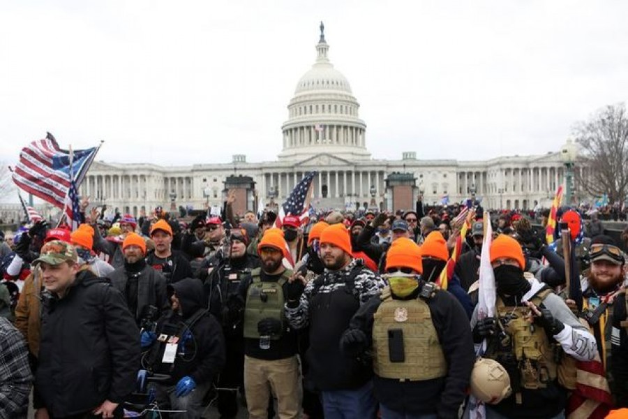 FILE PHOTO: Members of the far-right group Proud Boys make 'OK' hand gestures indicating "white power" as supporters of U.S. President Donald Trump gather in front of the U.S. Capitol Building to protest against the certification of the 2020 U.S. presidential election results by the U.S. Congress, in Washington, U.S., January 6, 2021. REUTERS/Jim Urquhart/File Photo