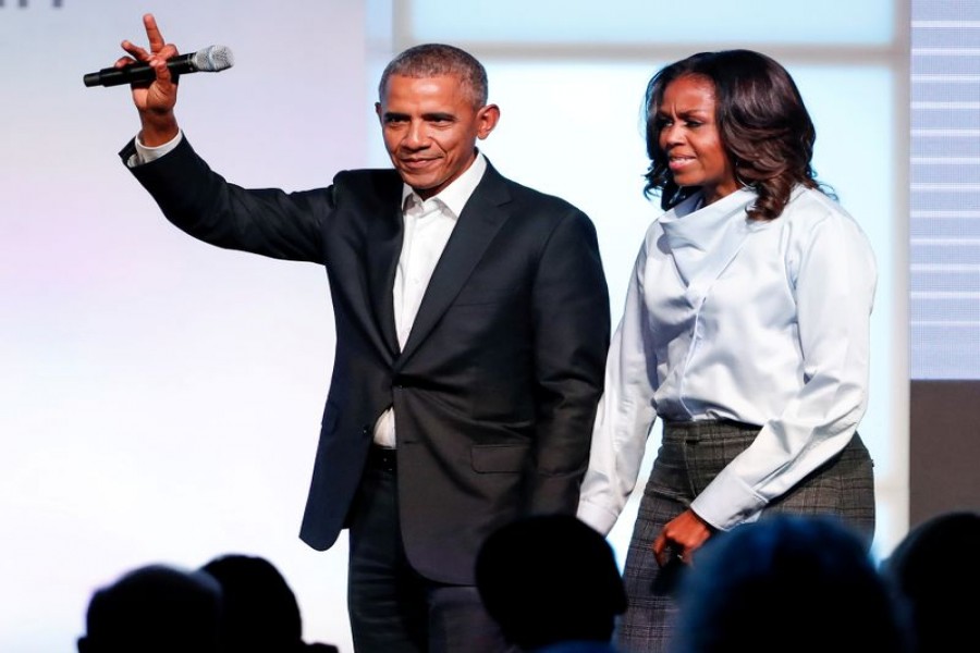 FILE PHOTO: Former US President Barack Obama and former first lady Michelle Obama greet guests during the first day of the Obama Foundation Summit in Chicago, Illinois, US, October 31, 2017. REUTERS/Kamil Krzaczynski/File Photo