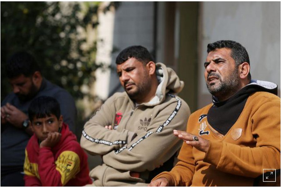 Palestinians from Abu Jama family sit outside their house in Khan Younis in the southern Gaza strip February 06, 2021. Reuters/Ibraheem Abu Mustafa