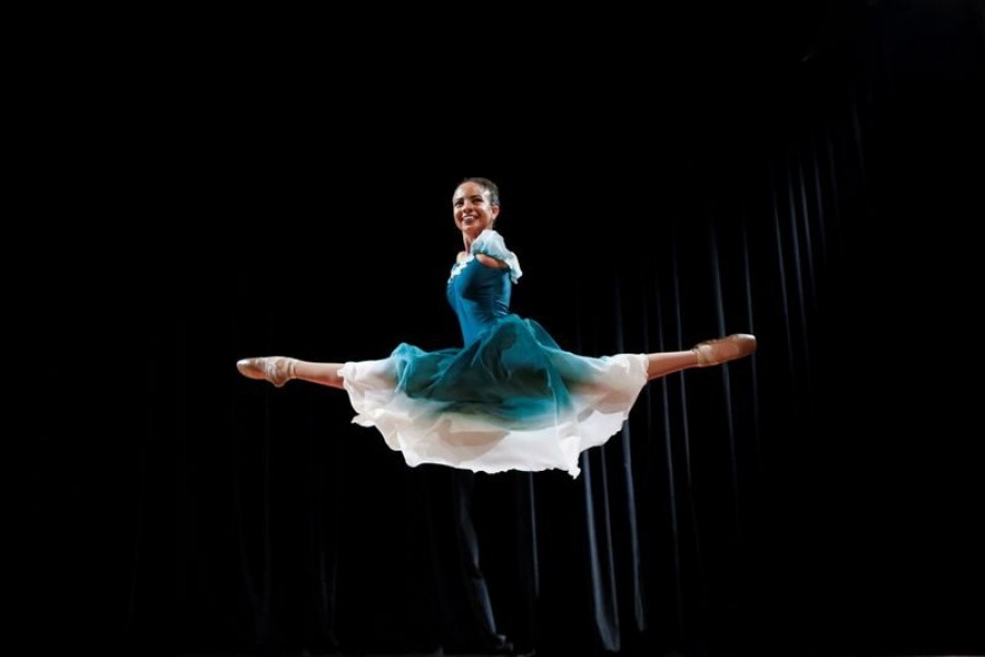 Vitoria Bueno, a 16-year-old dancer whose genetic condition left her without arms, jumps during a solo performance on stage at the Inatel Theater in Santa Rita do Sapucai, Brazil on February 5, 2021 — Reuters/Files