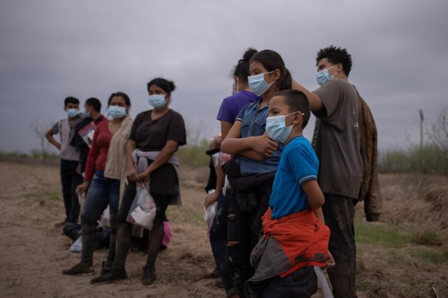 About a dozen asylum seeking unaccompanied minors from Central America are separated from other migrants by US Border Patrol agents after crossing the Rio Grande river into the United States from Mexico on a raft in Penitas, Texas, US on March 14, 2021 — Reuters photo