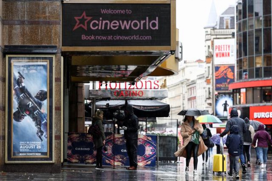 FILE PHOTO: People walk past a Cineworld in Leicester's Square, amid the coronavirus disease (COVID-19) outbreak in London, Britain, October 4, 2020. REUTERS/Henry Nicholls/File Photo