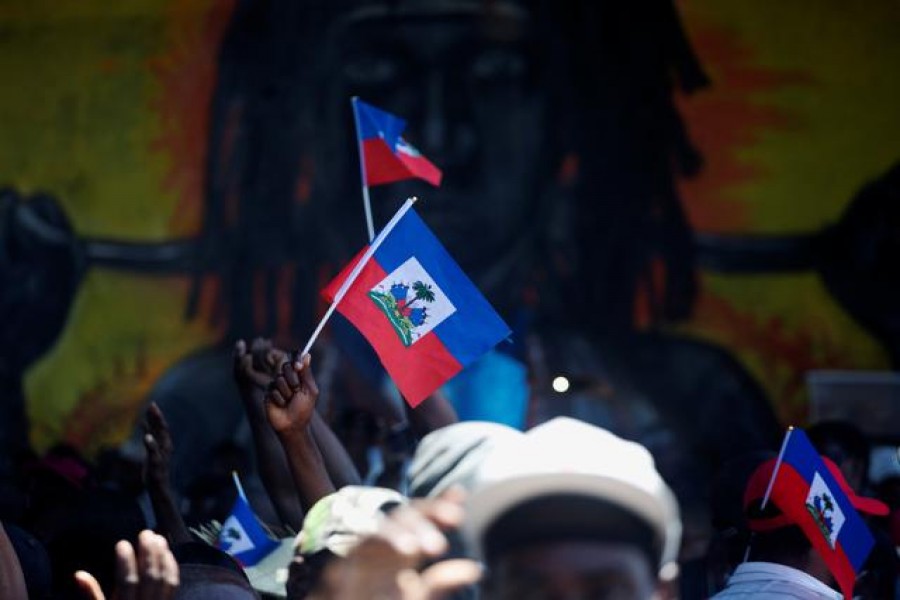 FILE PHOTO: Demonstrators hold Haiti's national flags during a protest against the government of President Jovenel Moise, in Port-au-Prince, Haiti March 28, 2021. REUTERS/Estailove ST-Val