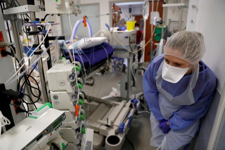 FILE PHOTO: A medical worker, wearing protective gear, works in the Intensive Care Unit (ICU) where patients suffering from the coronavirus disease (COVID-19) are treated at Cambrai hospital, France, April 1, 2021. REUTERS/Pascal Rossignol/File Photo