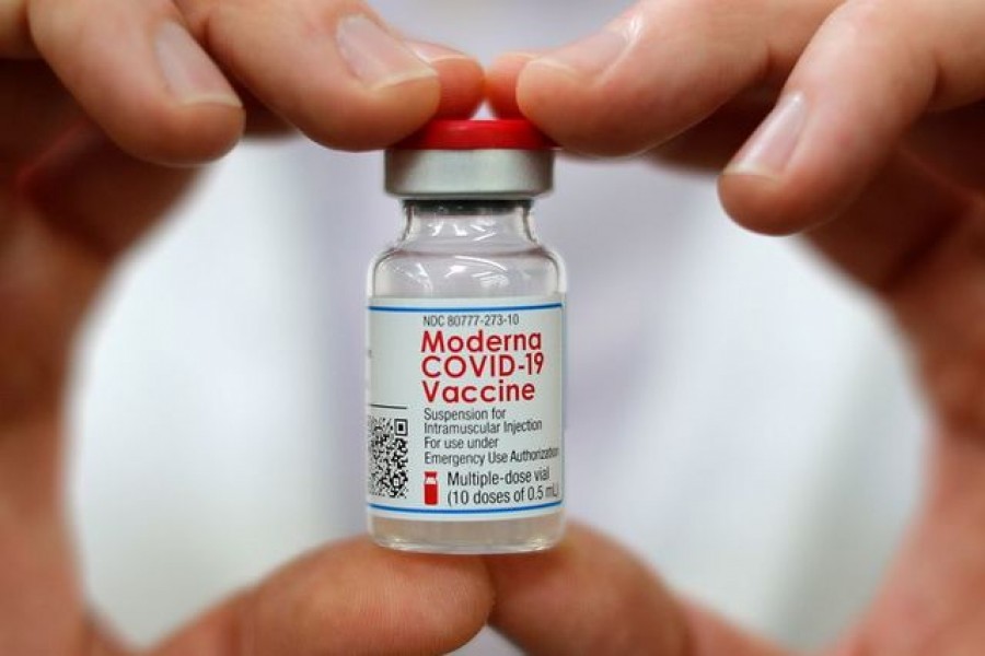 Walmart pharmacist holds a vial of the Moderna coronavirus disease (Covid-19) vaccine inside a Walmart department store as Walmart and other major US pharmacies take part in the Federal Retail Pharmacy Program, to increase vaccinations in the US in West Haven, Connecticut, US on February 17, 2021 — Reuters/Files