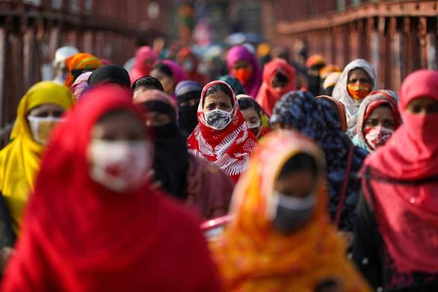 Garment workers returning from a workplace as factories reopened after the government has eased the restrictions amid concerns over the coronavirus disease (Covid-19) outbreak in Dhaka, May 04, 2020 – Reuters/Files