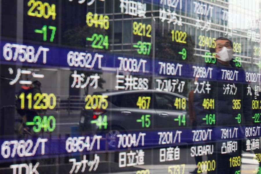 A man is reflected on a stock quotation board in Tokyo, Japan on February 26, 2021 — Reuters/Files