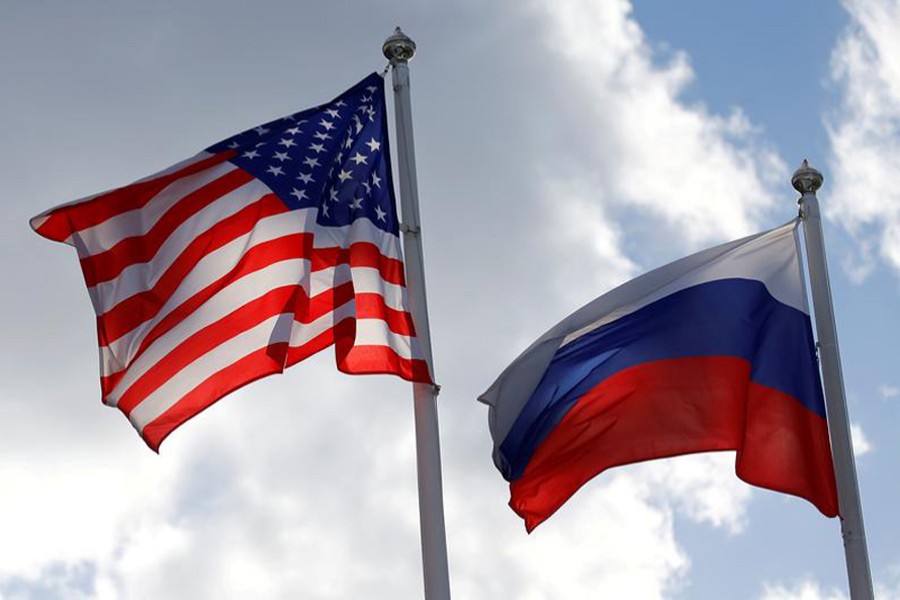 Russian and US state flags fly near a factory in Vsevolozhsk, Leningrad Region, Russia on March 27, 2019 — Reuters/Files