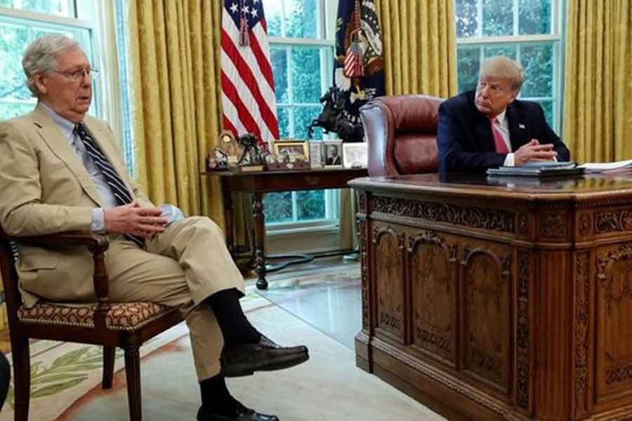 US President Donald Trump listens to Senate Majority Leader Mitch McConnell (R-KY) speak about legislation for additional coronavirus aid in the Oval Office at the White House in Washington last year -Reuters file photo