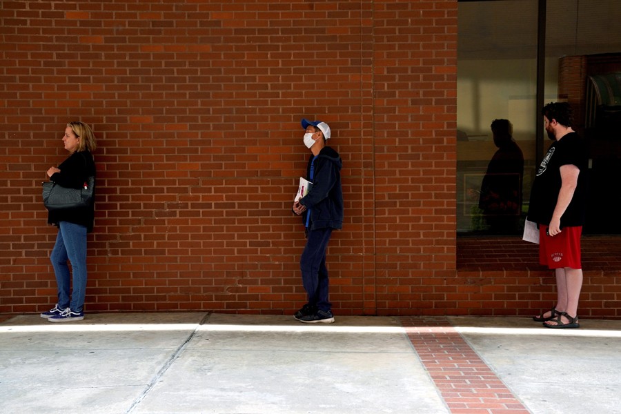 People who lost their jobs wait in line to file for unemployment benefits, following an outbreak of the coronavirus disease (Covid-19), at an Arkansas Workforce Center in Fort Smith, Arkansas, US on April 6, 2020 — Reuters/Files