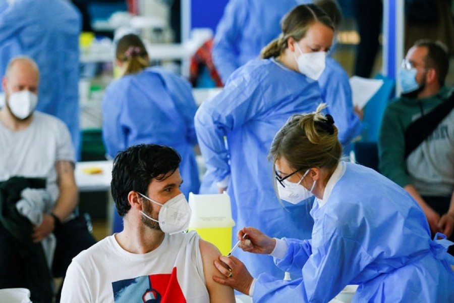 A man receives a dose of the AstraZeneca COVID-19 vaccine in the Central Mosque in Ehrenfeld suburb, amid the coronavirus disease (COVID-19) pandemic, in Cologne, Germany, May 8, 2021 - Reuters