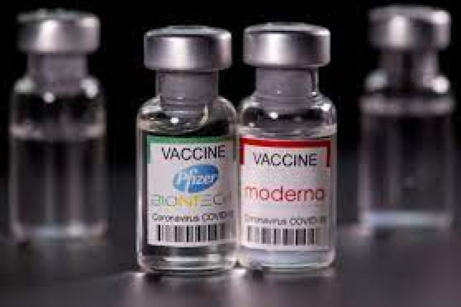 Vials with Pfizer-BioNTech and Moderna coronavirus disease (COVID-19) vaccine labels are seen in this illustration picture taken March 19, 2021. REUTERS/Dado Ruvic/Illustration/File Photo